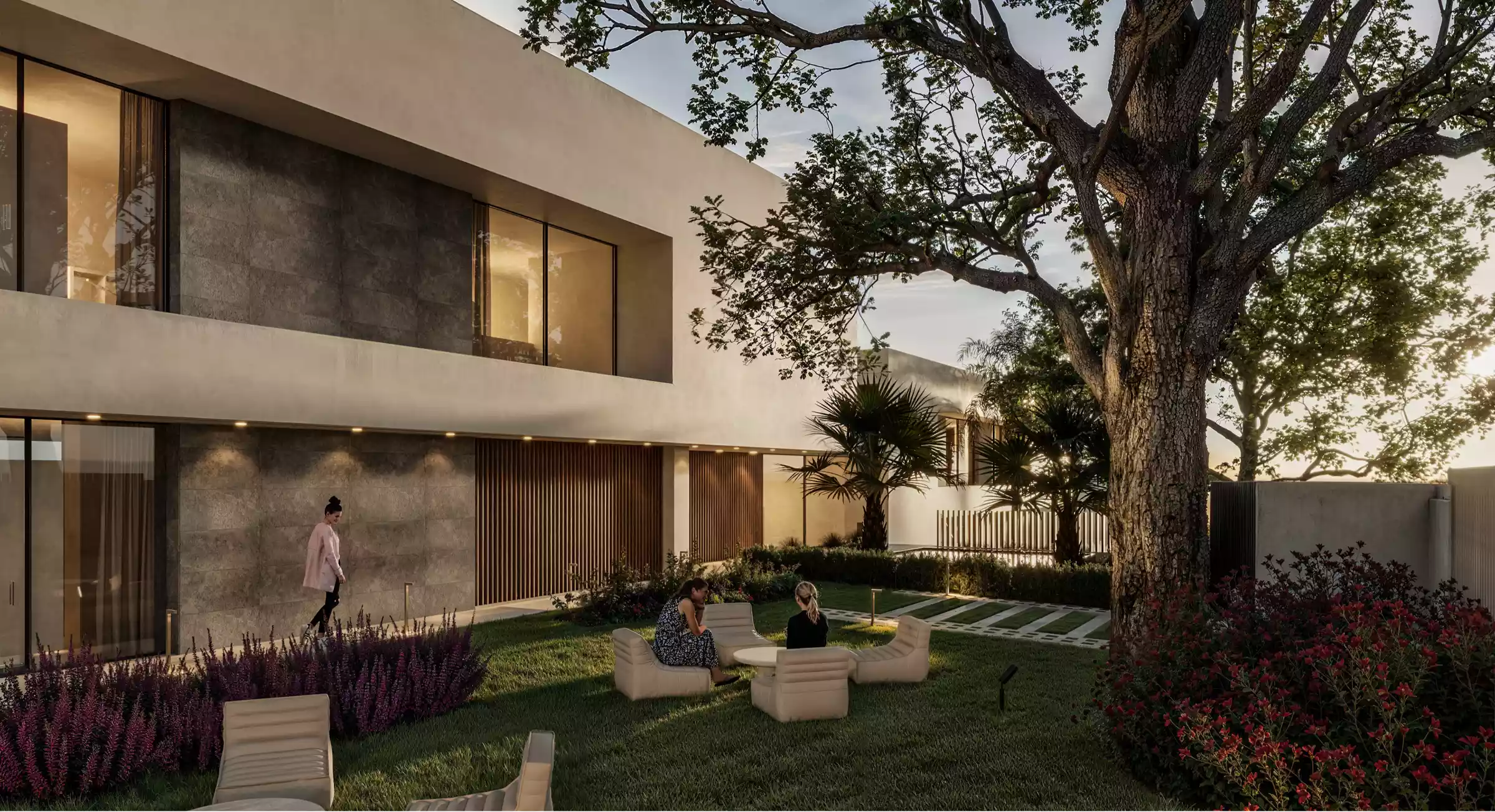 Tranquil garden lounge with modern seating under a tree, designed for quiet reflection and connection during recovery.”