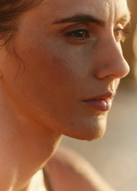 Person splashing water on their face, symbolizing freshness and nourishment.