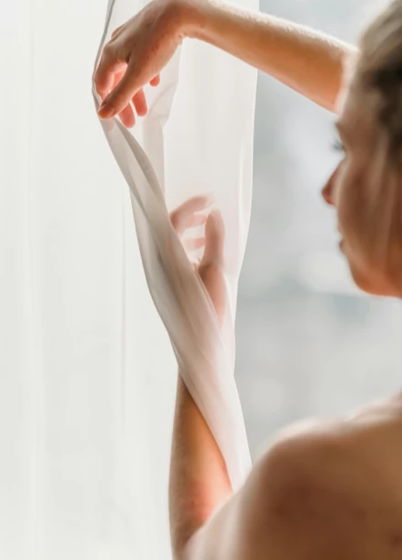 Hand holding a small item inside a car, suggesting care, simplicity, and ease.